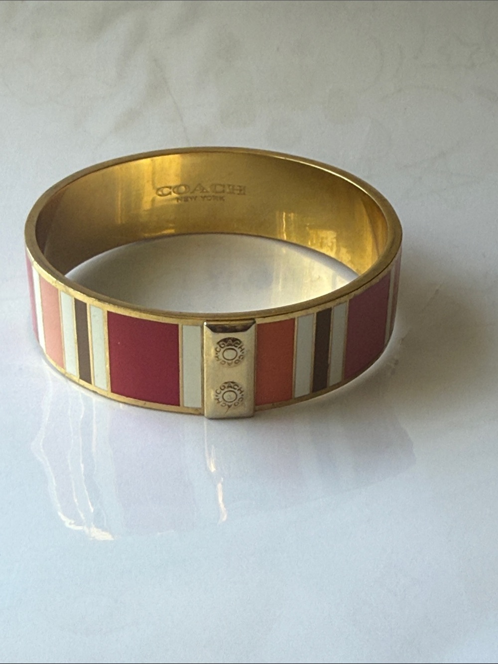 Coach Gold-Tone Enamel Stripe Bangle in Pink, Cream and Coral